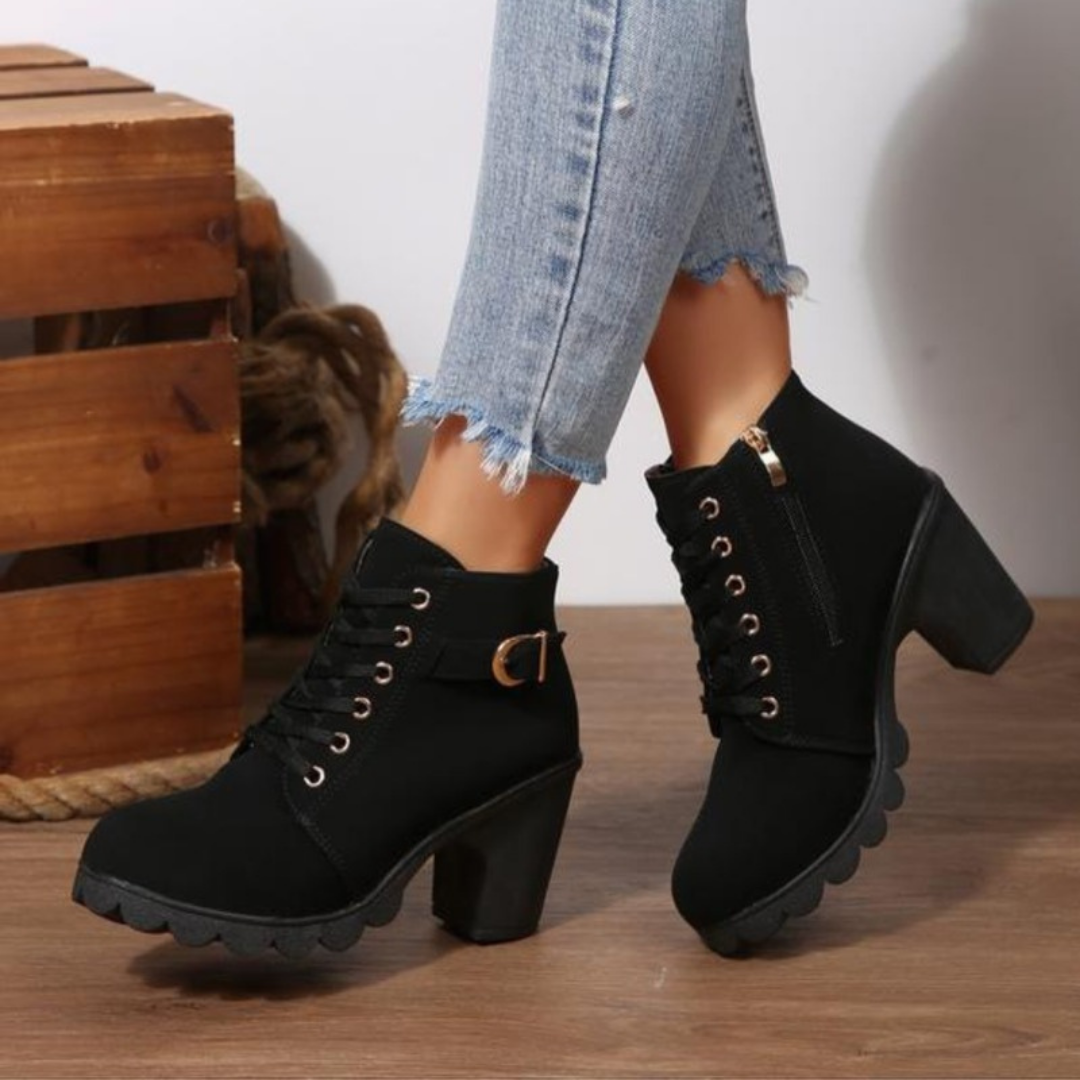 Women's black chunky ankle boots with lace-up and zipper closure, metal buckle detail, PU upper
