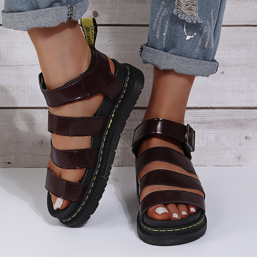 Red women's open-toe sandal with buckle strap and thick platform sole, top-down view