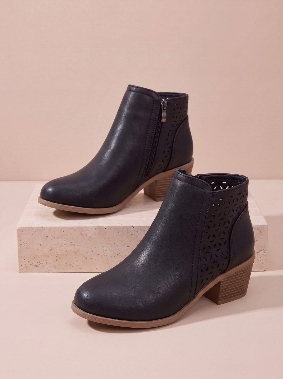 A pair of women's black leather ankle boots
