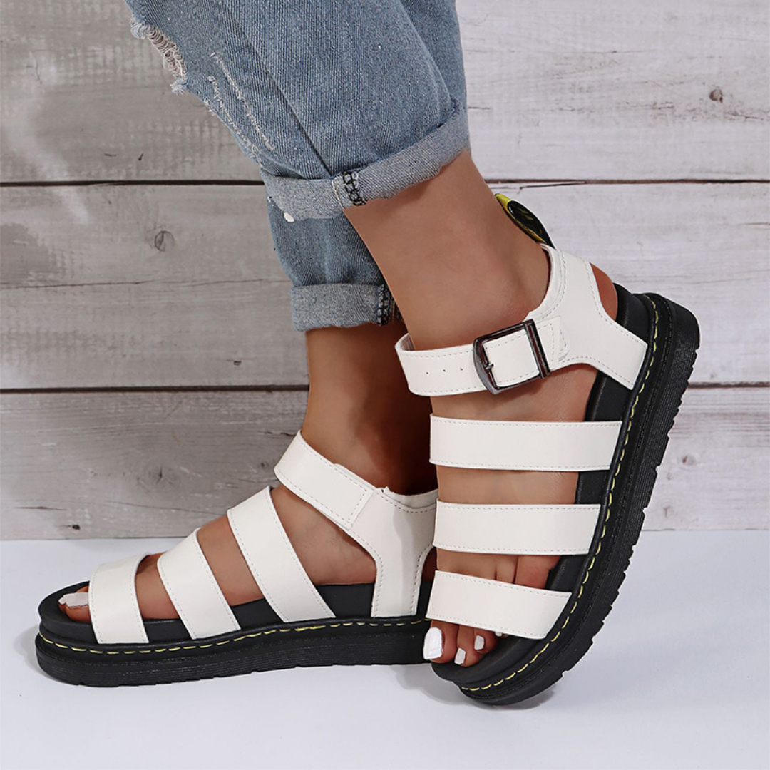 White women's open-toe sandal with buckle strap and thick platform sole, top-down view