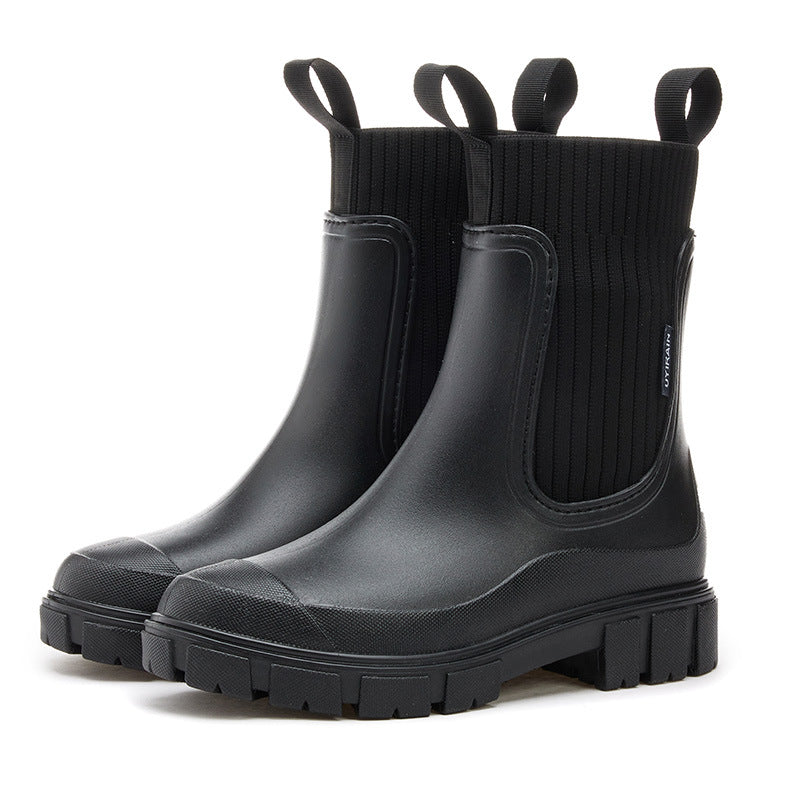 Close-up of pink PVC ankle boot elastic closure and ankle-height construction