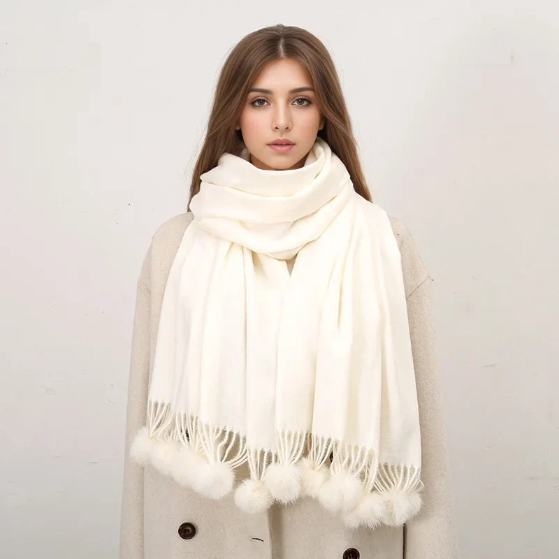 Cashmere scarf with pom pom embellishment styled casually