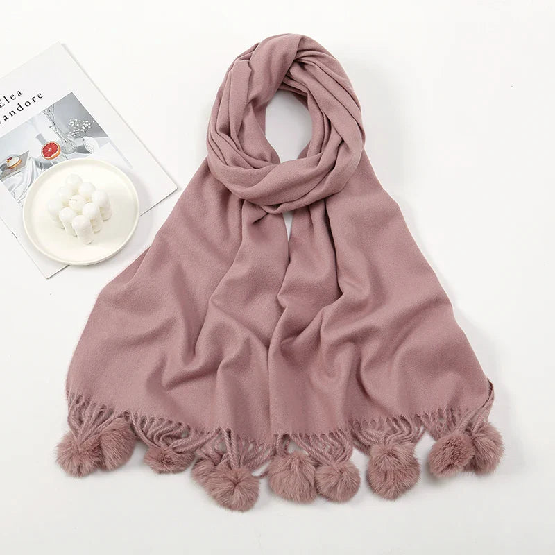 Cashmere scarf featuring pom pom trim edge detail view