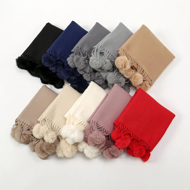 Cashmere scarf with pom pom trim shown from different angle
