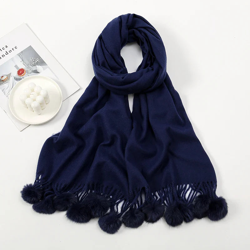 Cashmere scarf with pom pom trim displayed flat showing full length