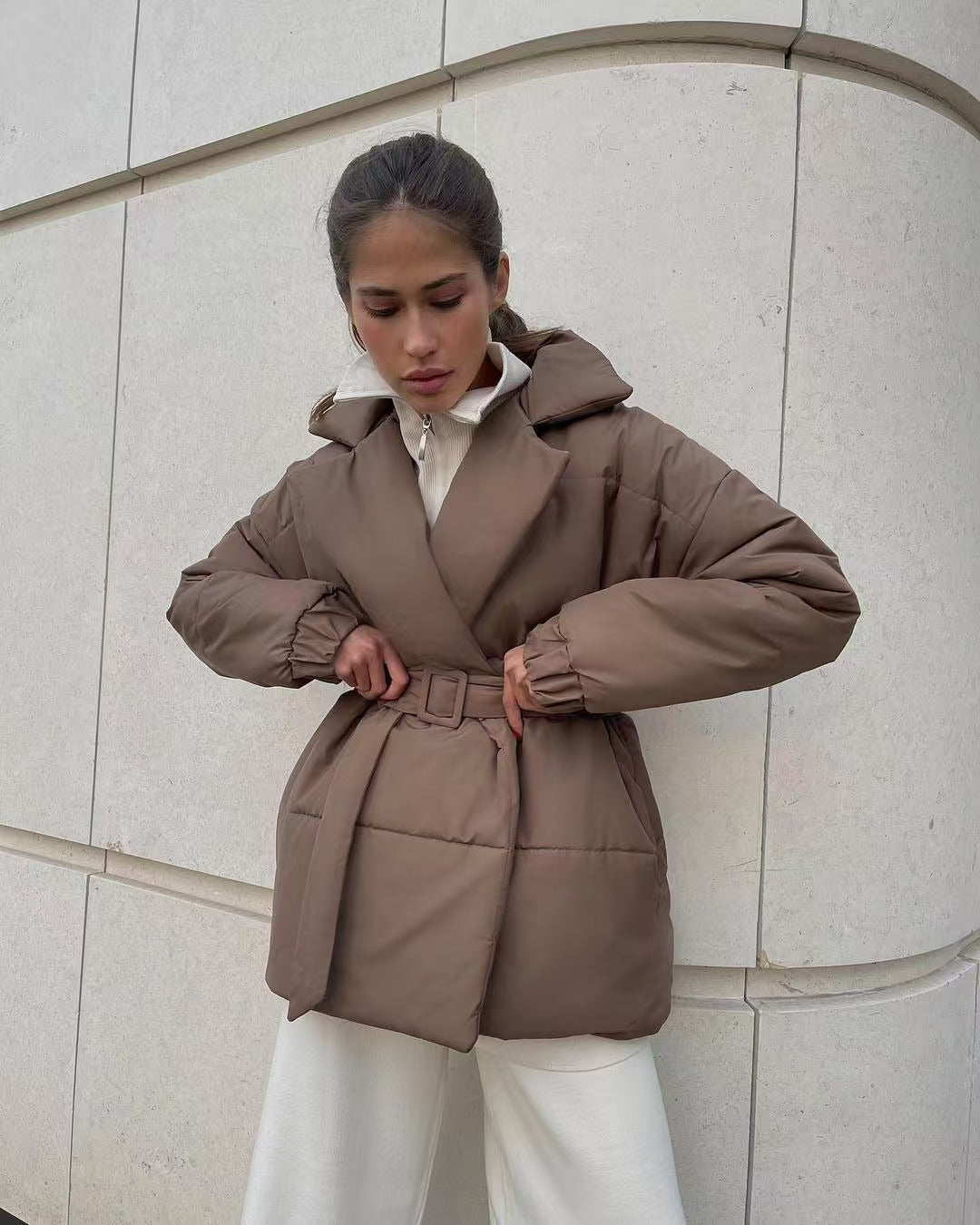 Fitted puffer jacket showing side profile and sleeve detail for women