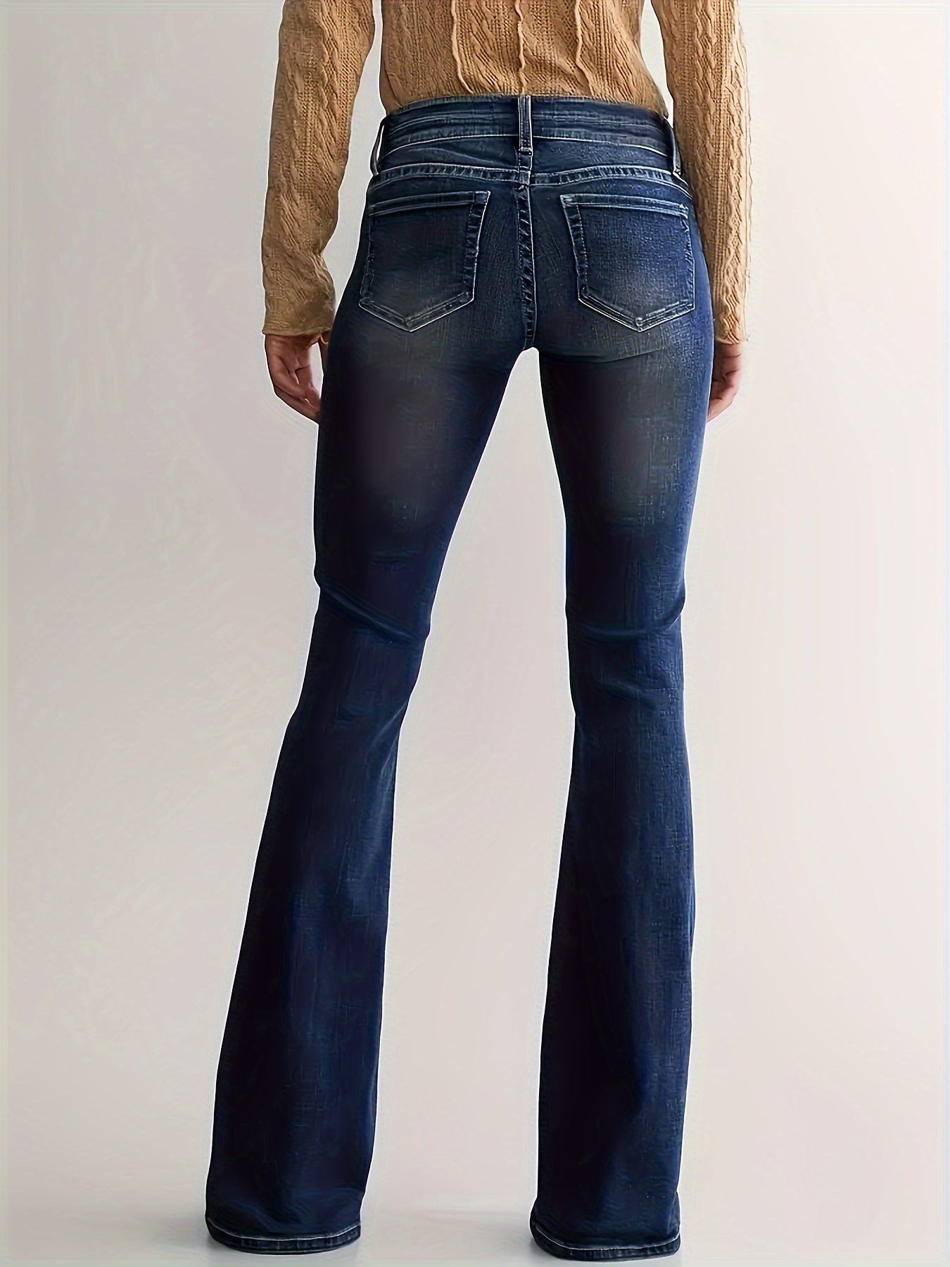 Denim flared jeans with flared hem detail on model