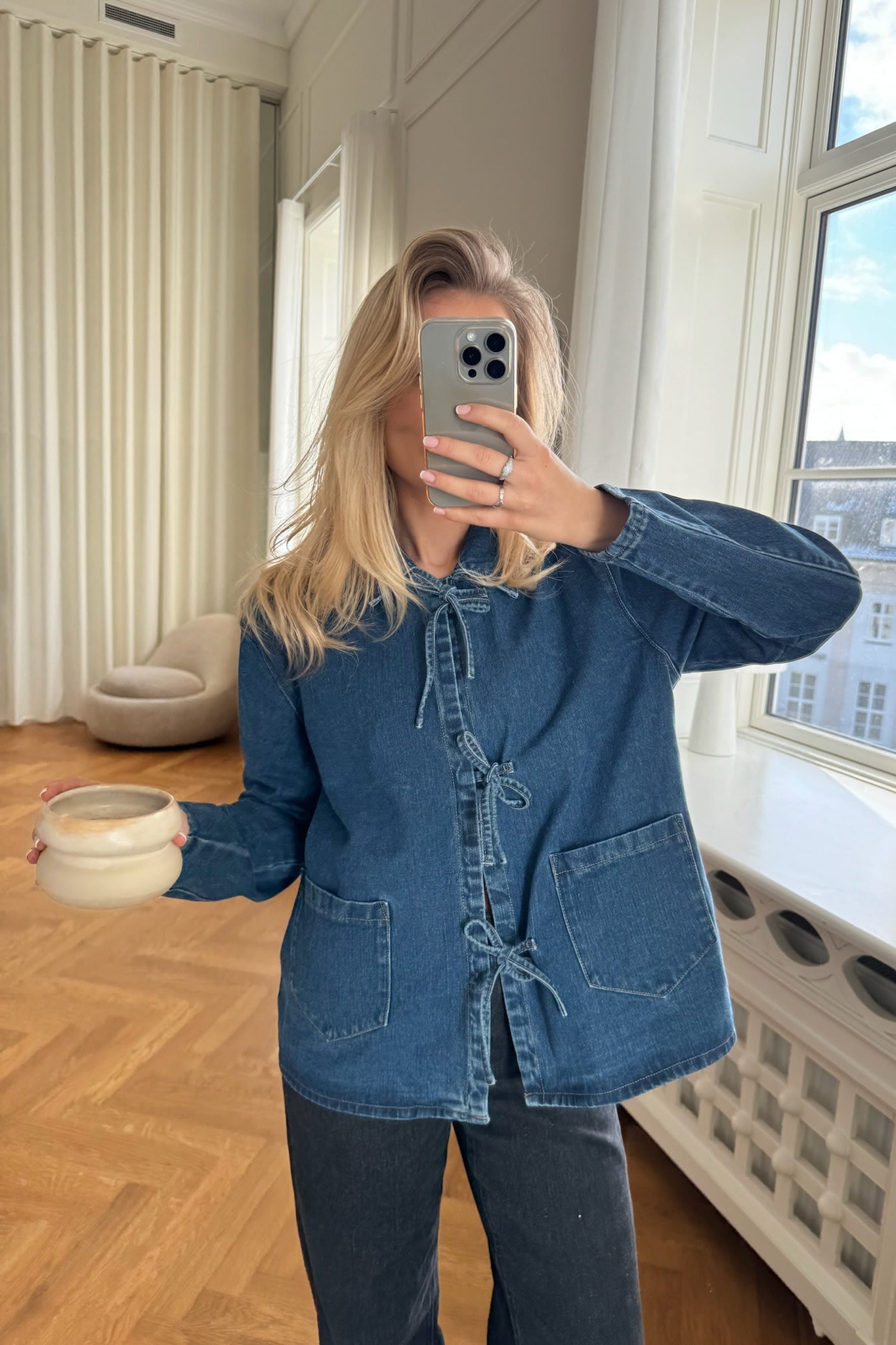 Women's cotton denim jacket with tie waist closure, front view on model