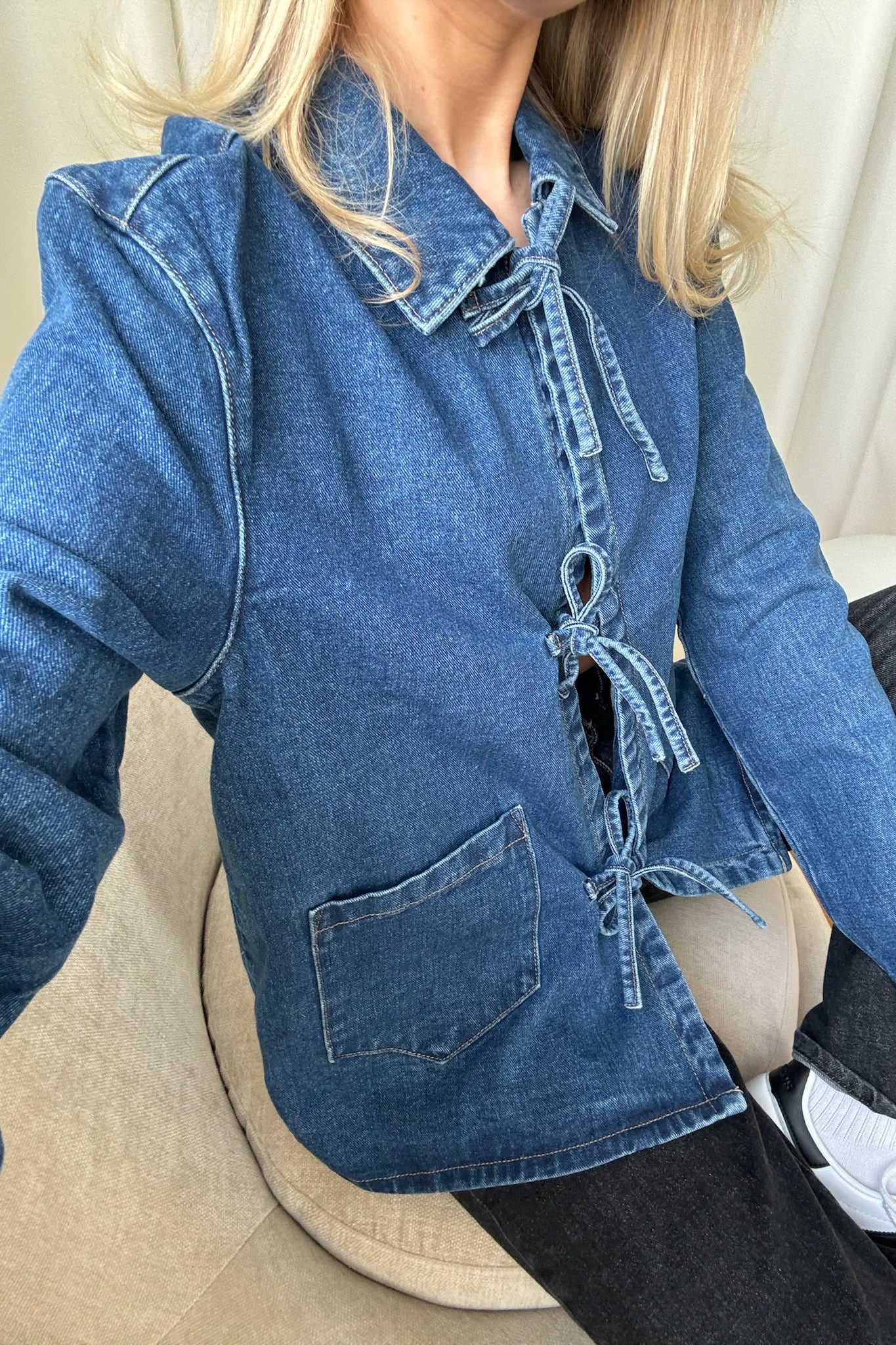 Women's denim jacket with tie waist, regular length, shown from the back