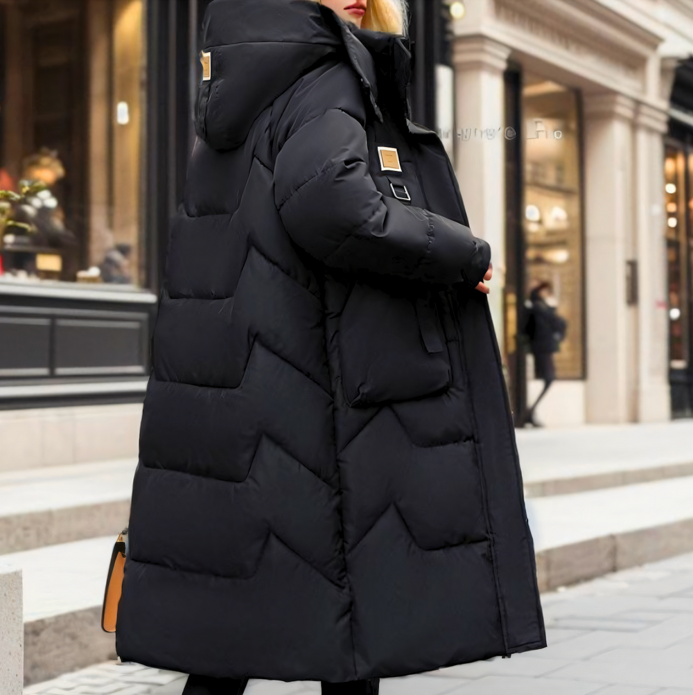 long padded winter coat featuring hood and zip closure displayed on model from side angle