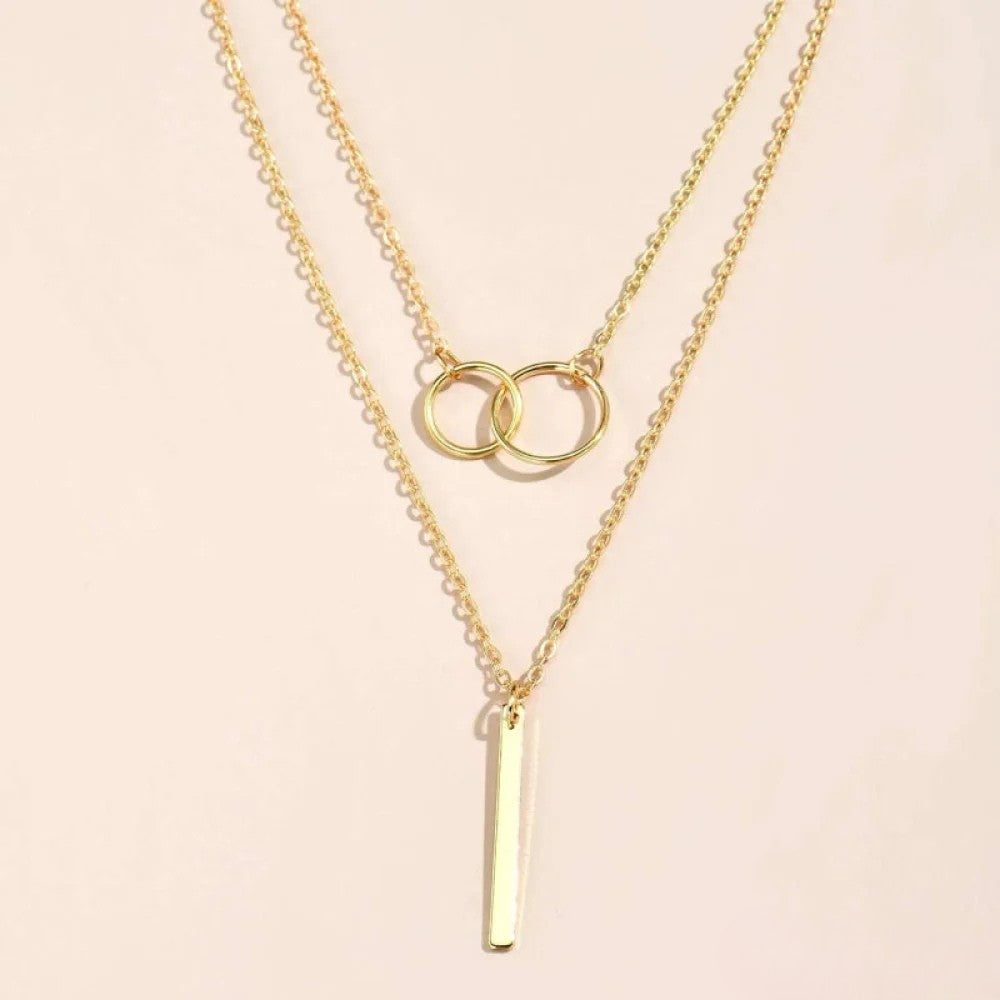 Layered necklace with double circle pendant in gold finish