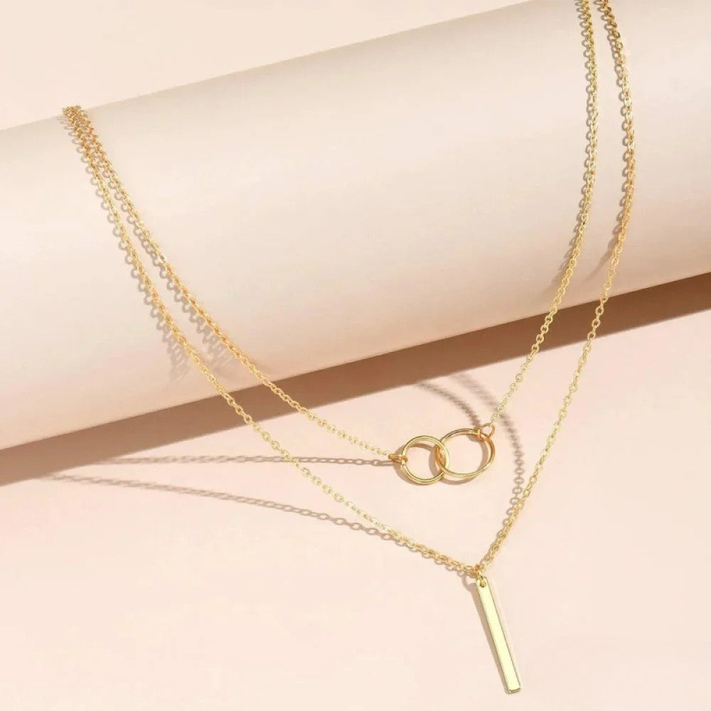 Gold chain necklace featuring linked circular pendant design