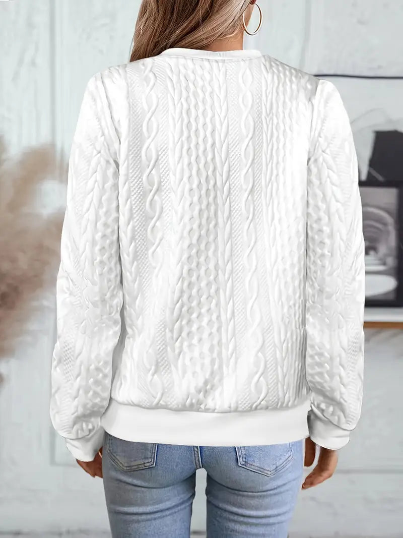 Cable-knit cardigan with round neckline worn casually