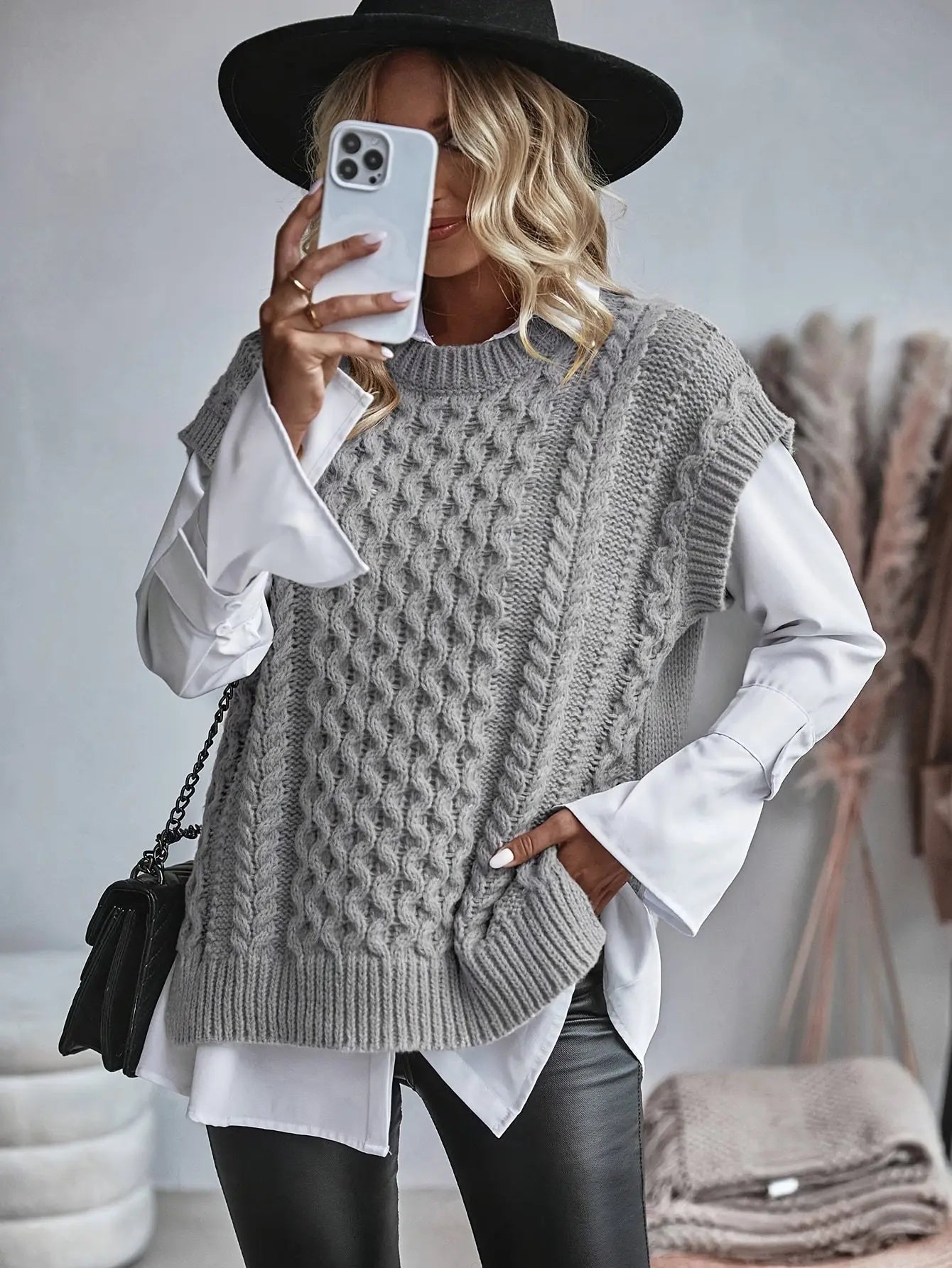 sleeveless fitted knit garment shown on model from side perspective
