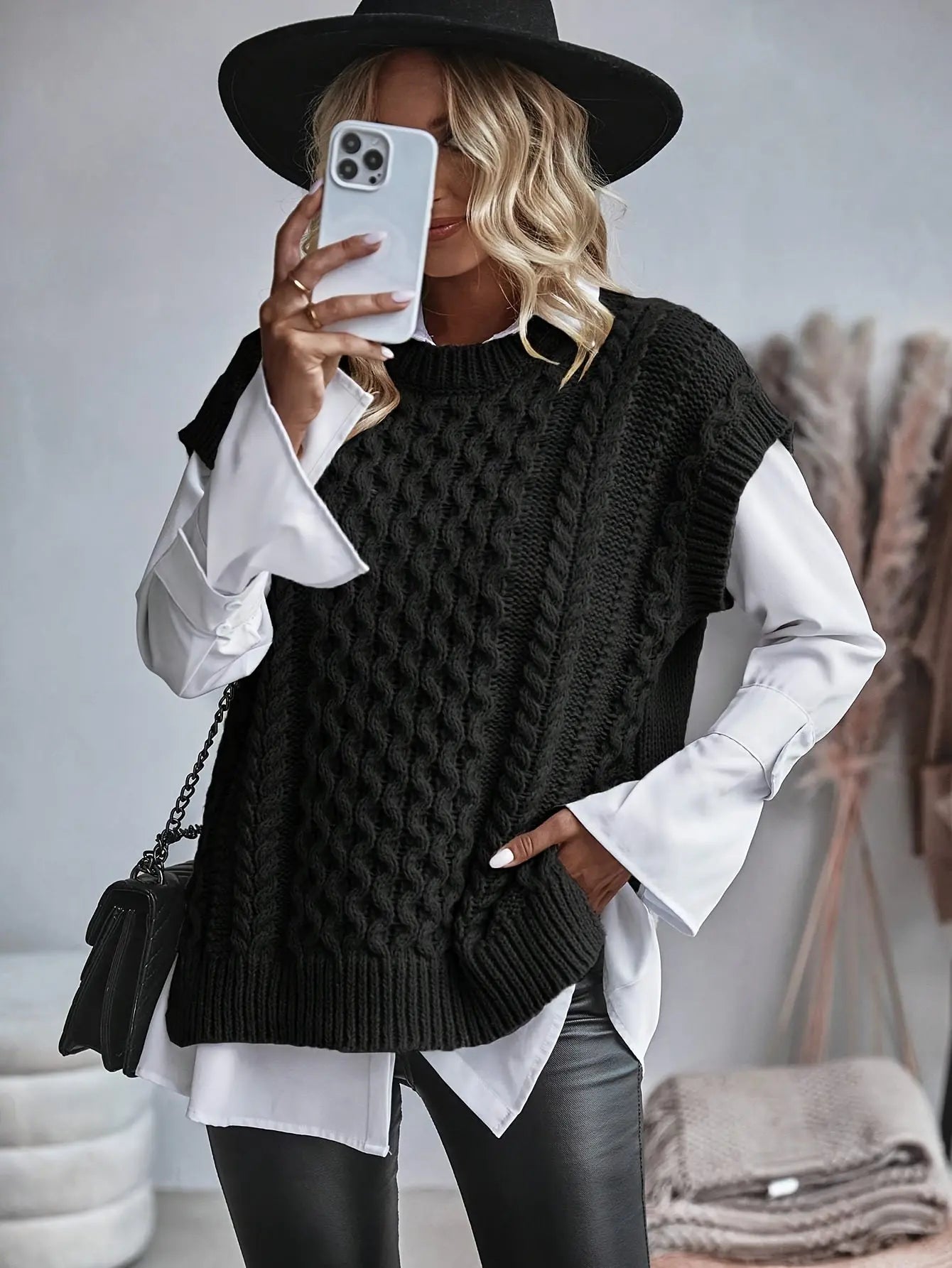 sleeveless fitted knit top displayed on model from front angle