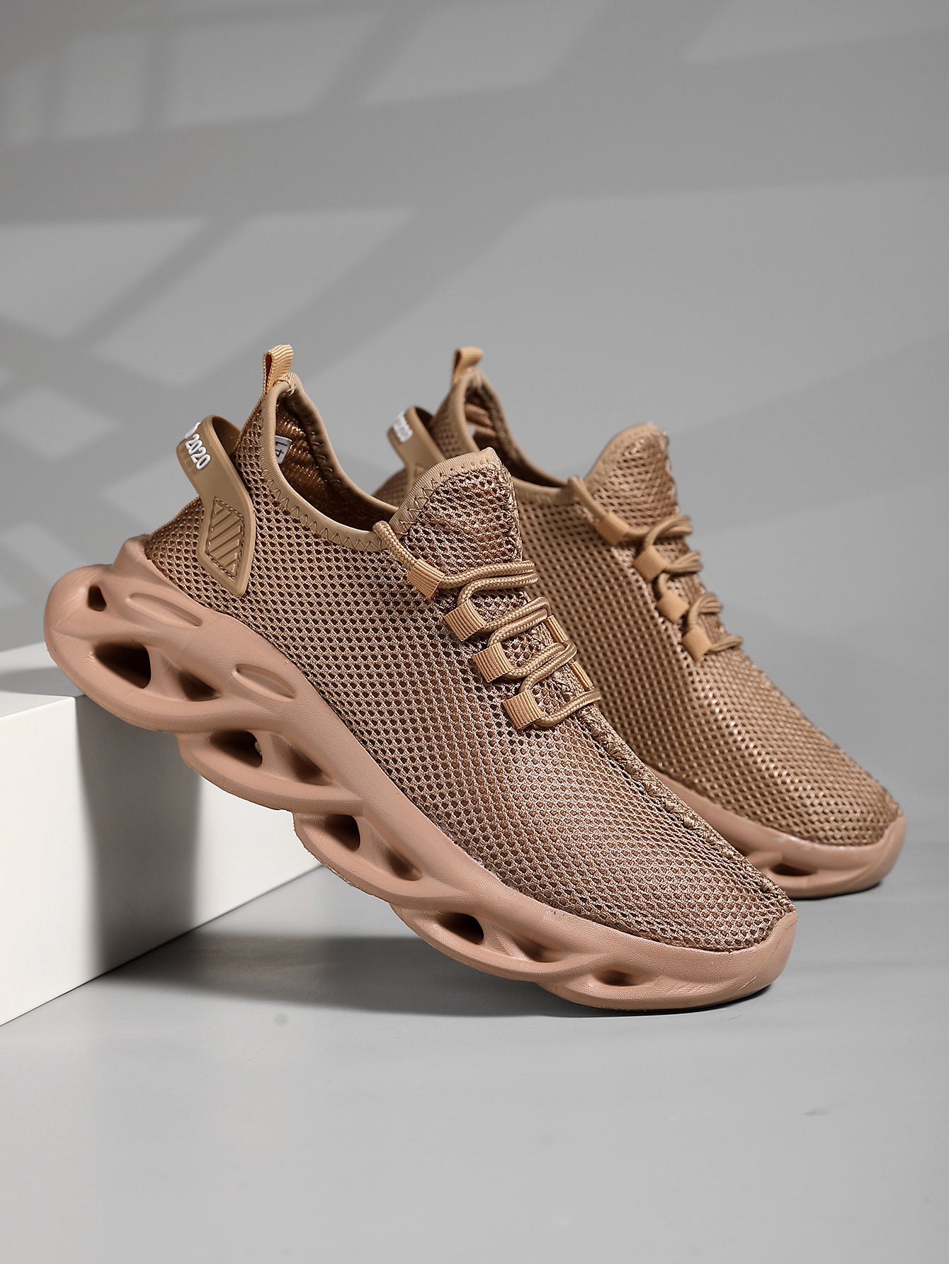 Running footwear with sculpted midsole and grip outsole