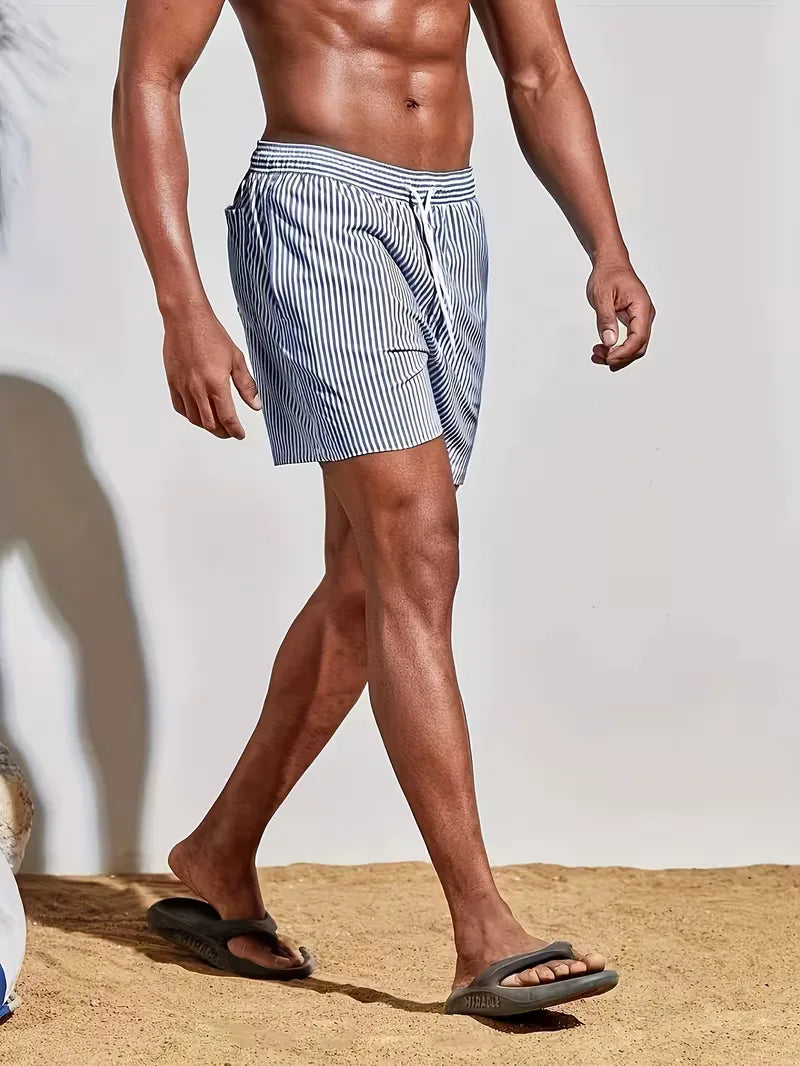 Person wearing striped swim shorts
