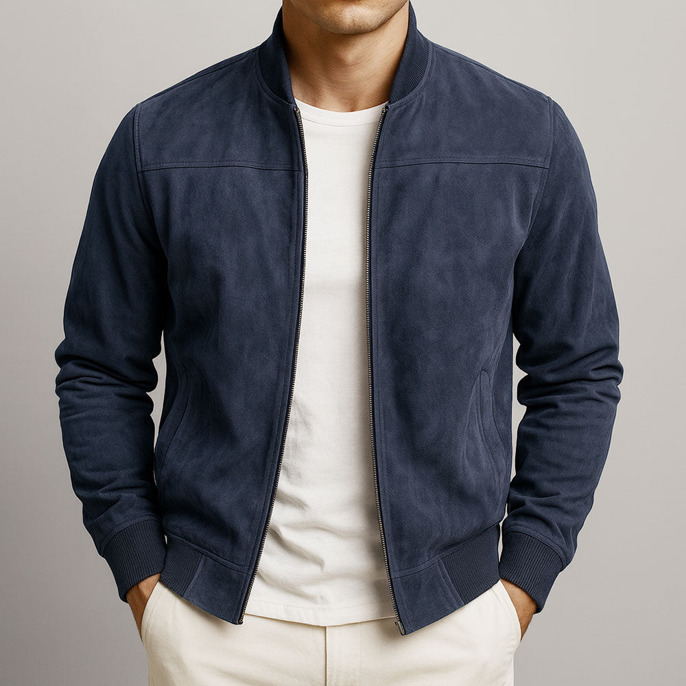 Man wearing suede bomber jacket with hands in pockets showing relaxed fit