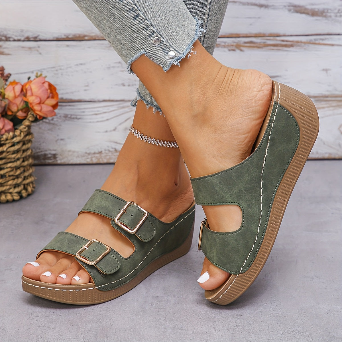 Side profile view of women's Boston slip-on sandal highlighting the contoured sole and buckle strap detail