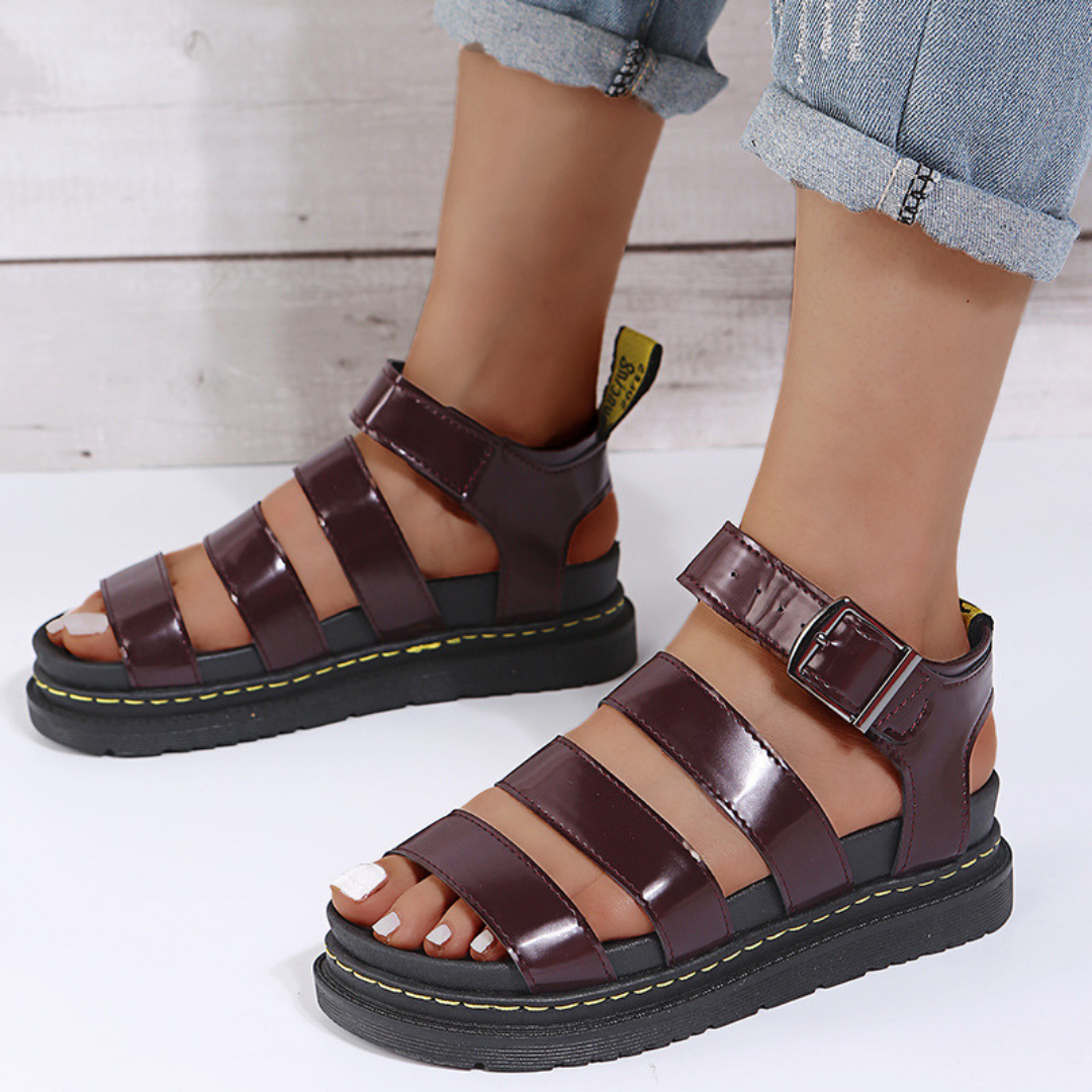 Red women's thick-sole open-toe sandal with buckle fastening, angled rear view