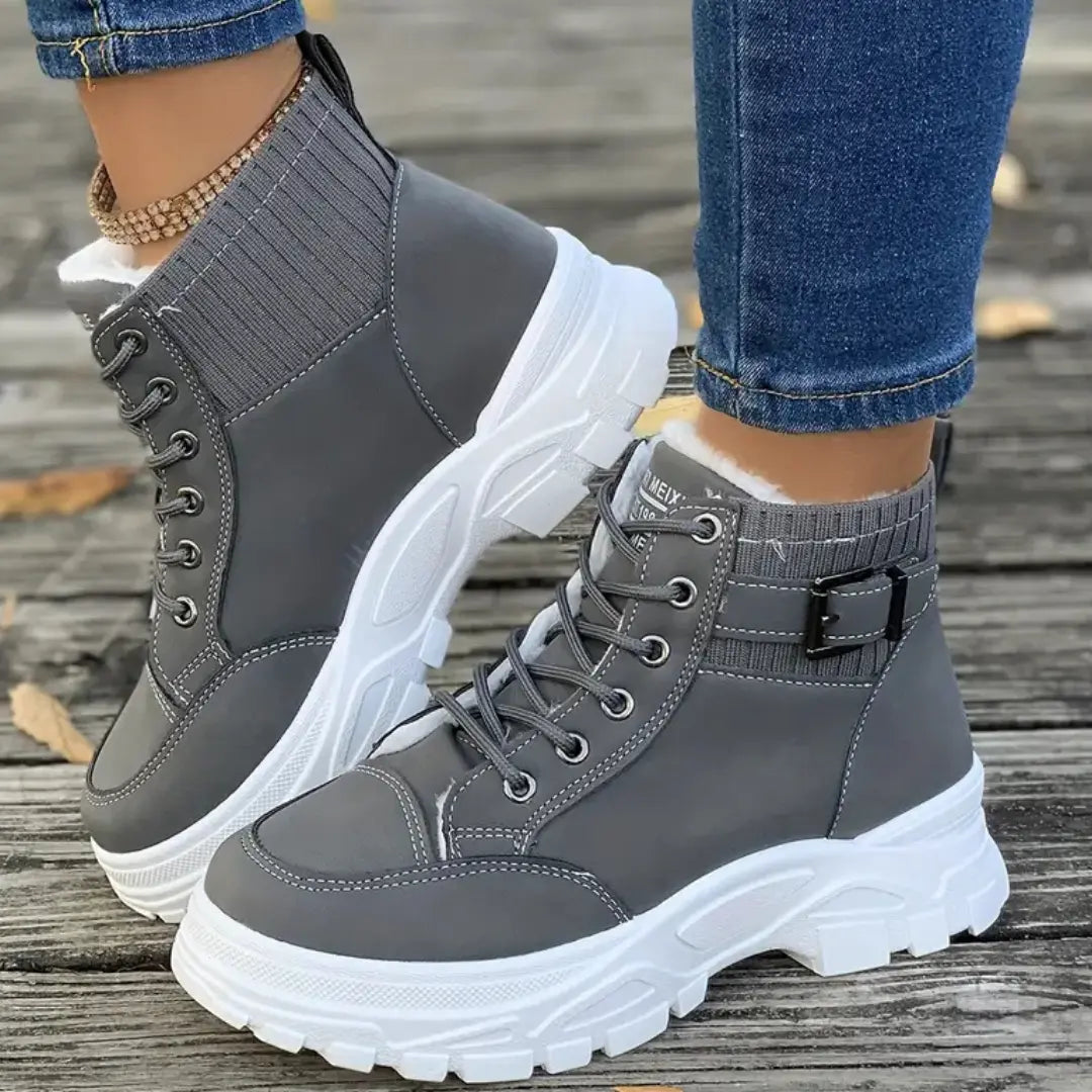 Lace-up ankle boots featuring thick platform base and synthetic upper