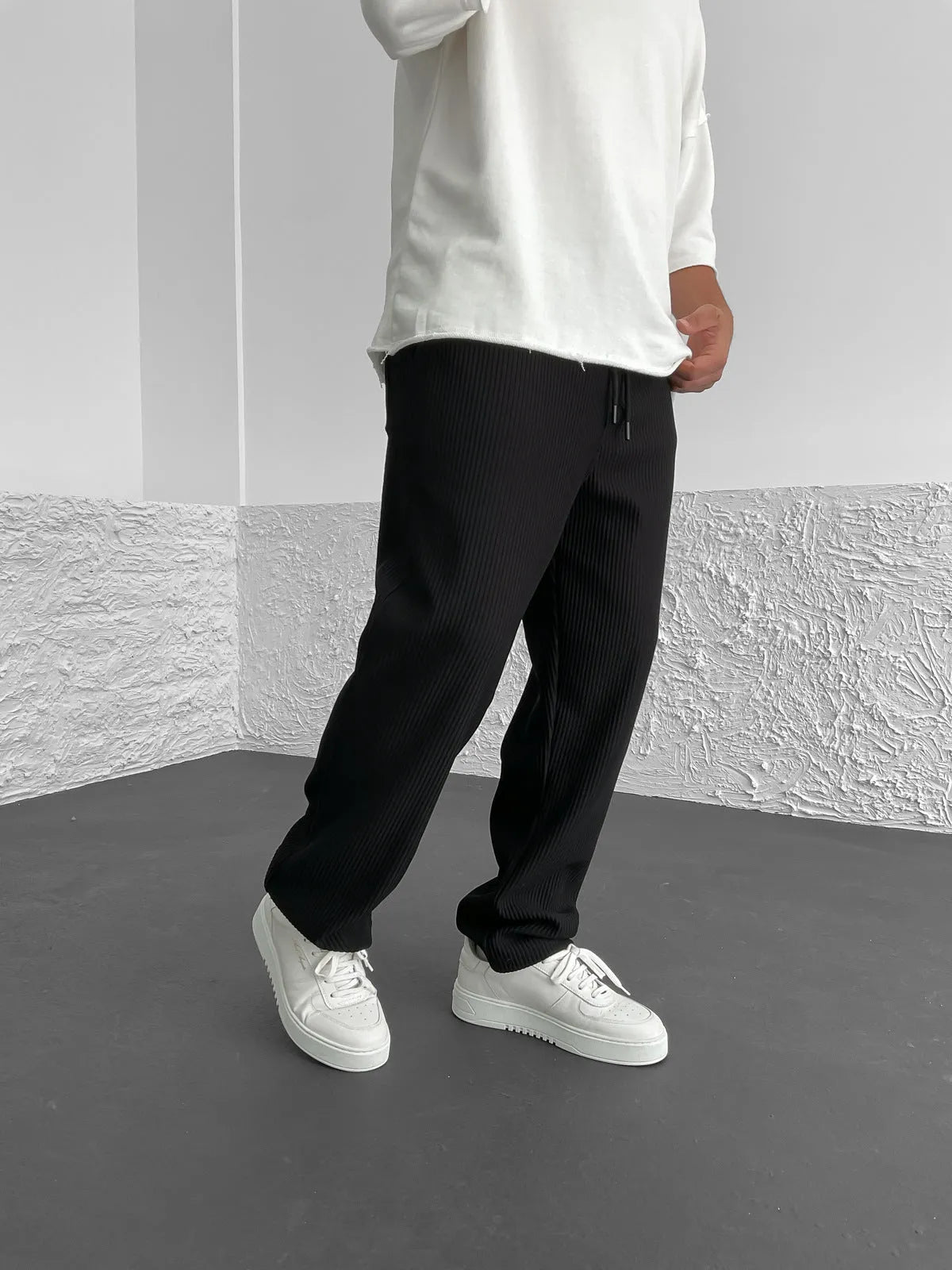 Cotton trousers showing relaxed fit through hip and thigh
