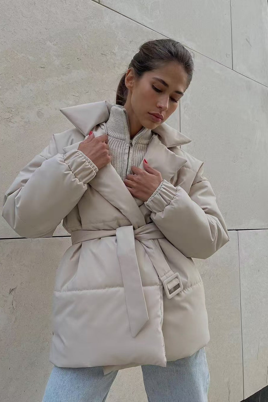 Puffer jacket detail showing quilted stitching pattern and fitted waist
