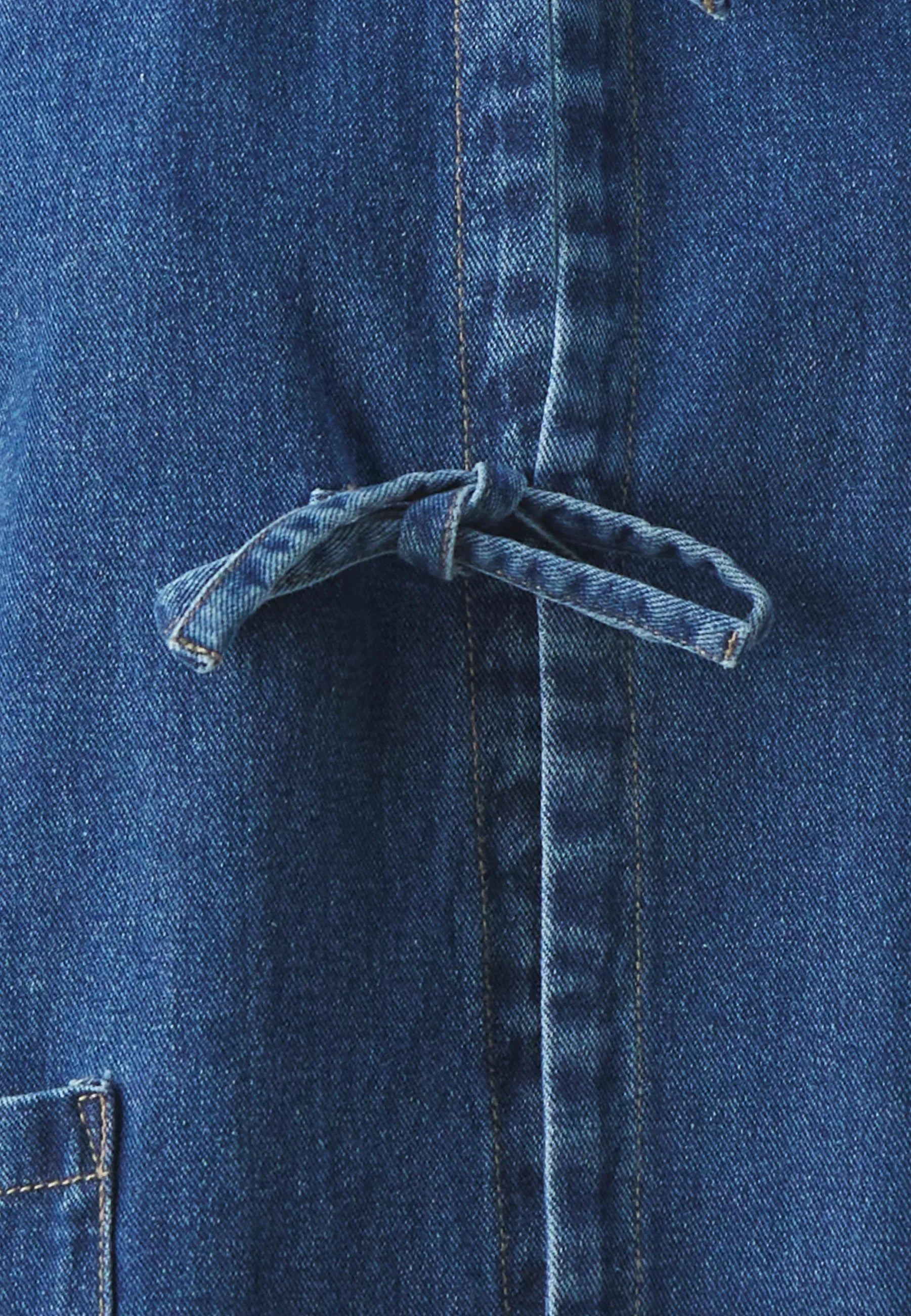Women's relaxed fit denim jacket styled for casual wear, full-length view