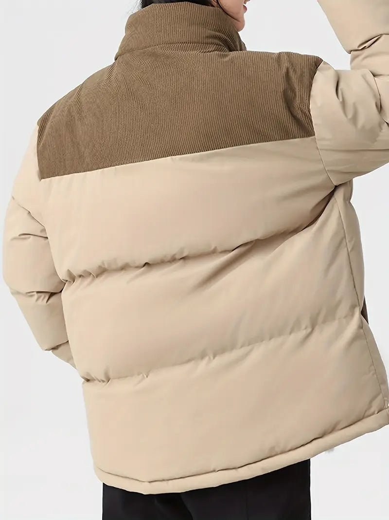 corduroy panel puffer jacket showing quilted texture and side panel detail in studio lighting