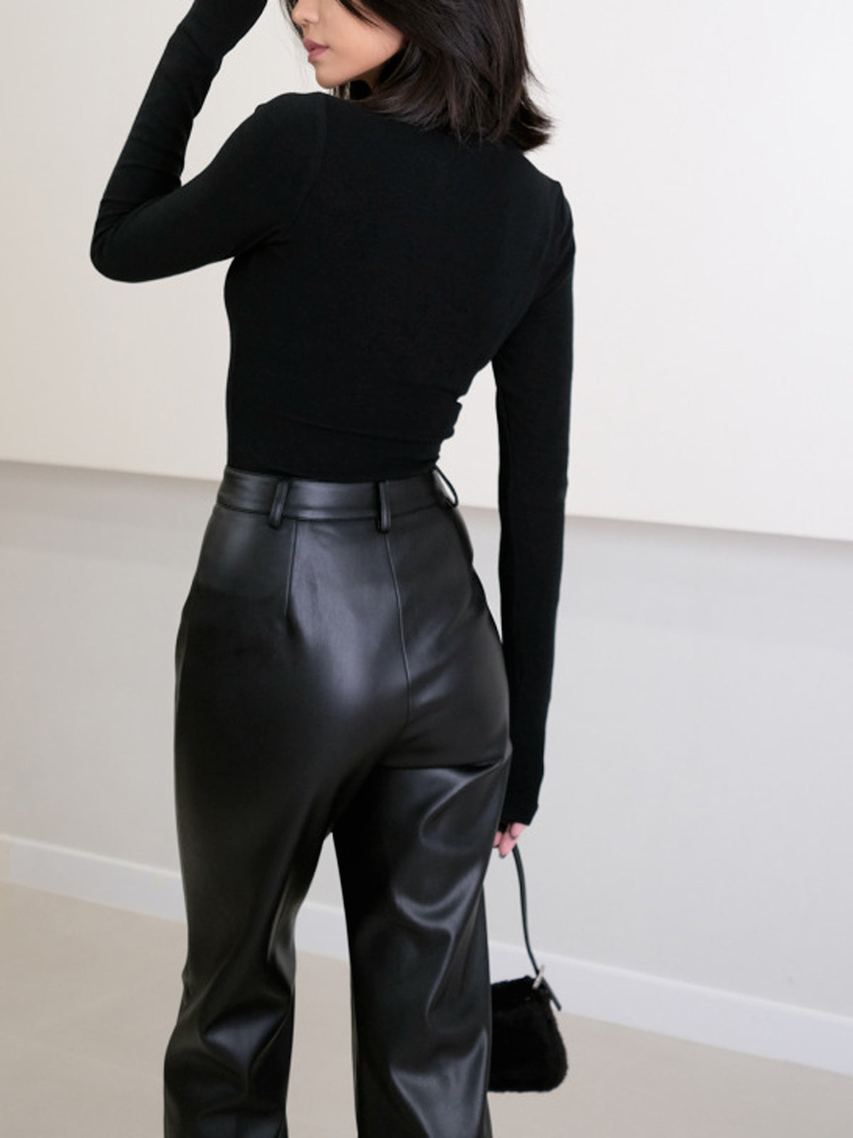 Women's leather-look straight trousers showcasing the front design