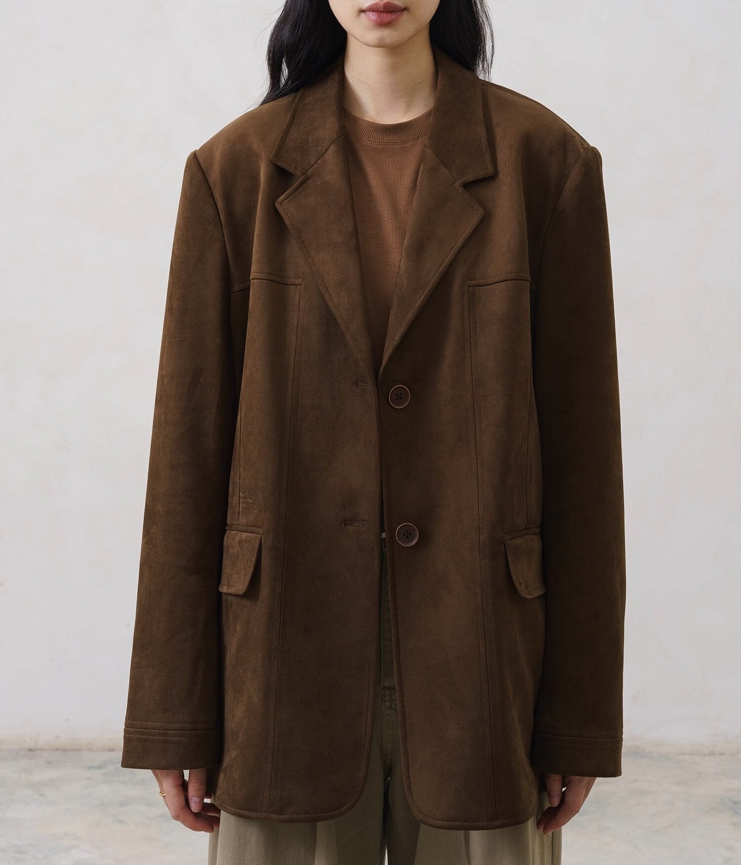 wool blazer with notched lapels and structured shoulders on model
