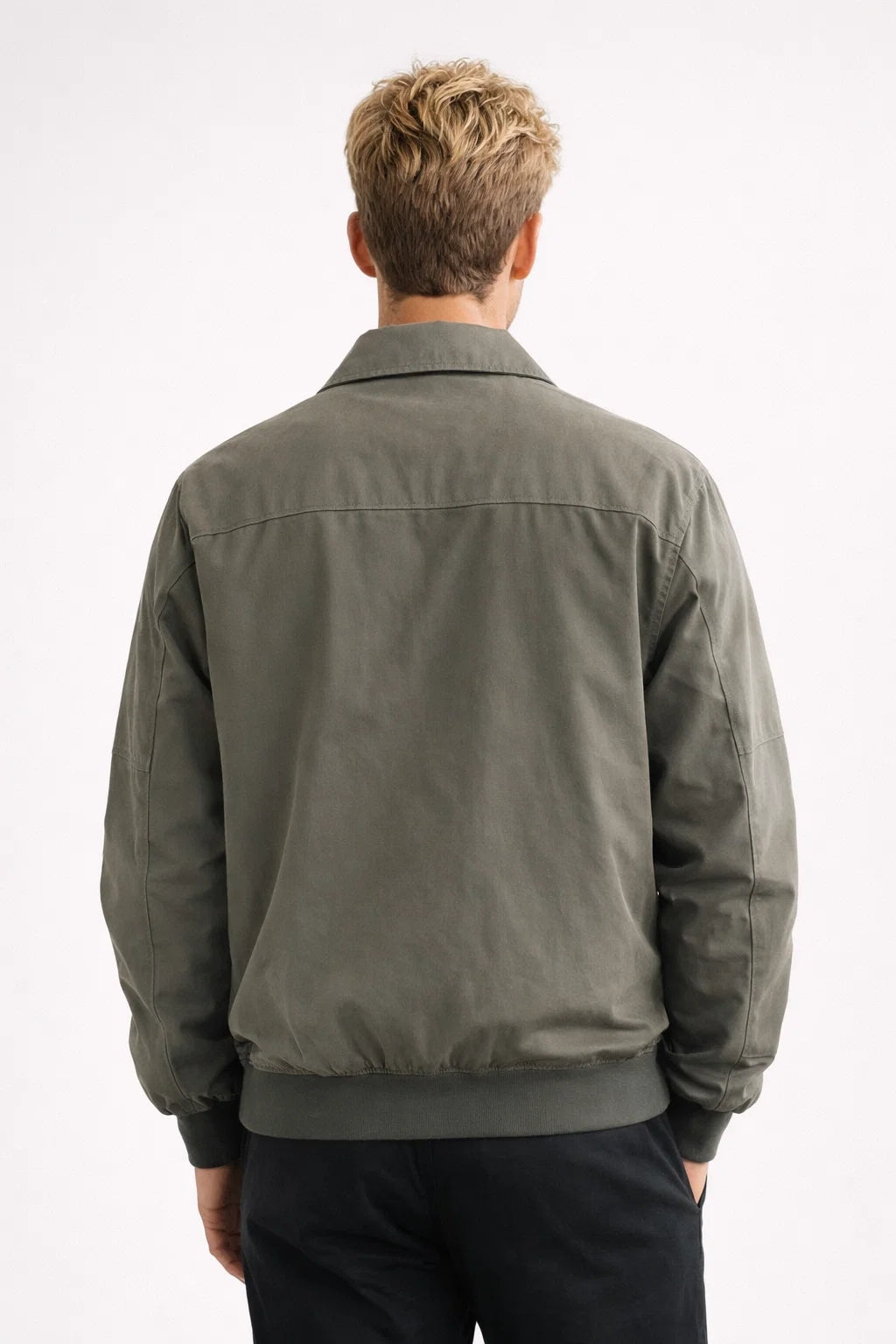 Detailed view of the zipped side pocket and panel stitching on the casual jacket