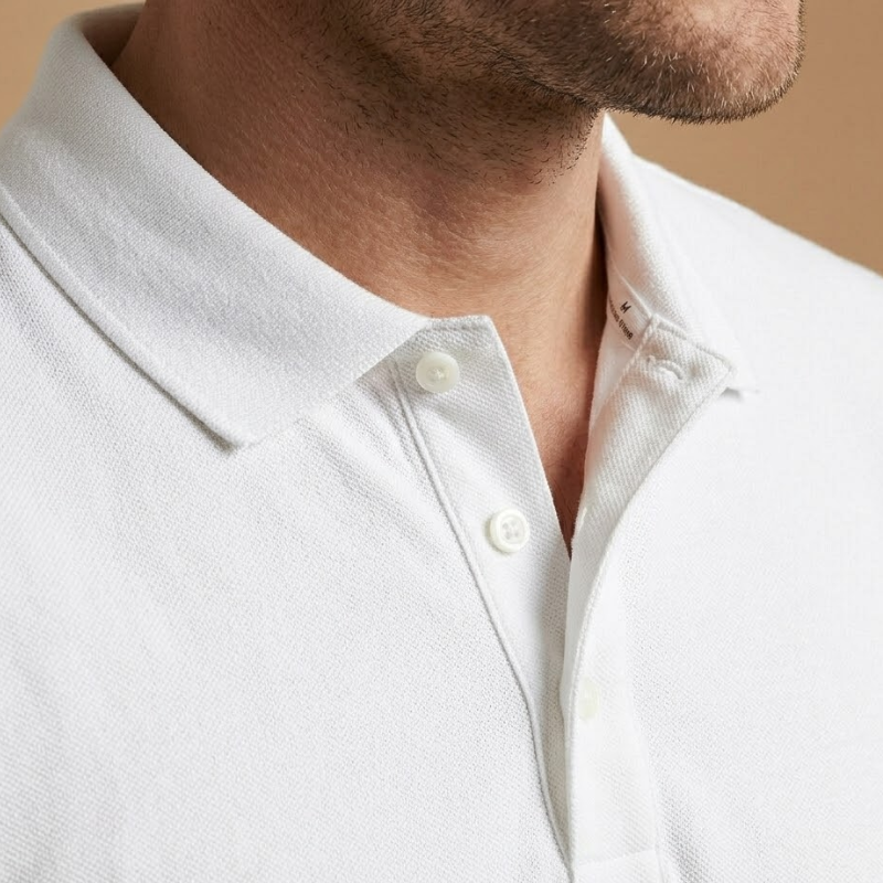 Close-up of the smooth knitted texture and stitching detail on the men's polo shirt