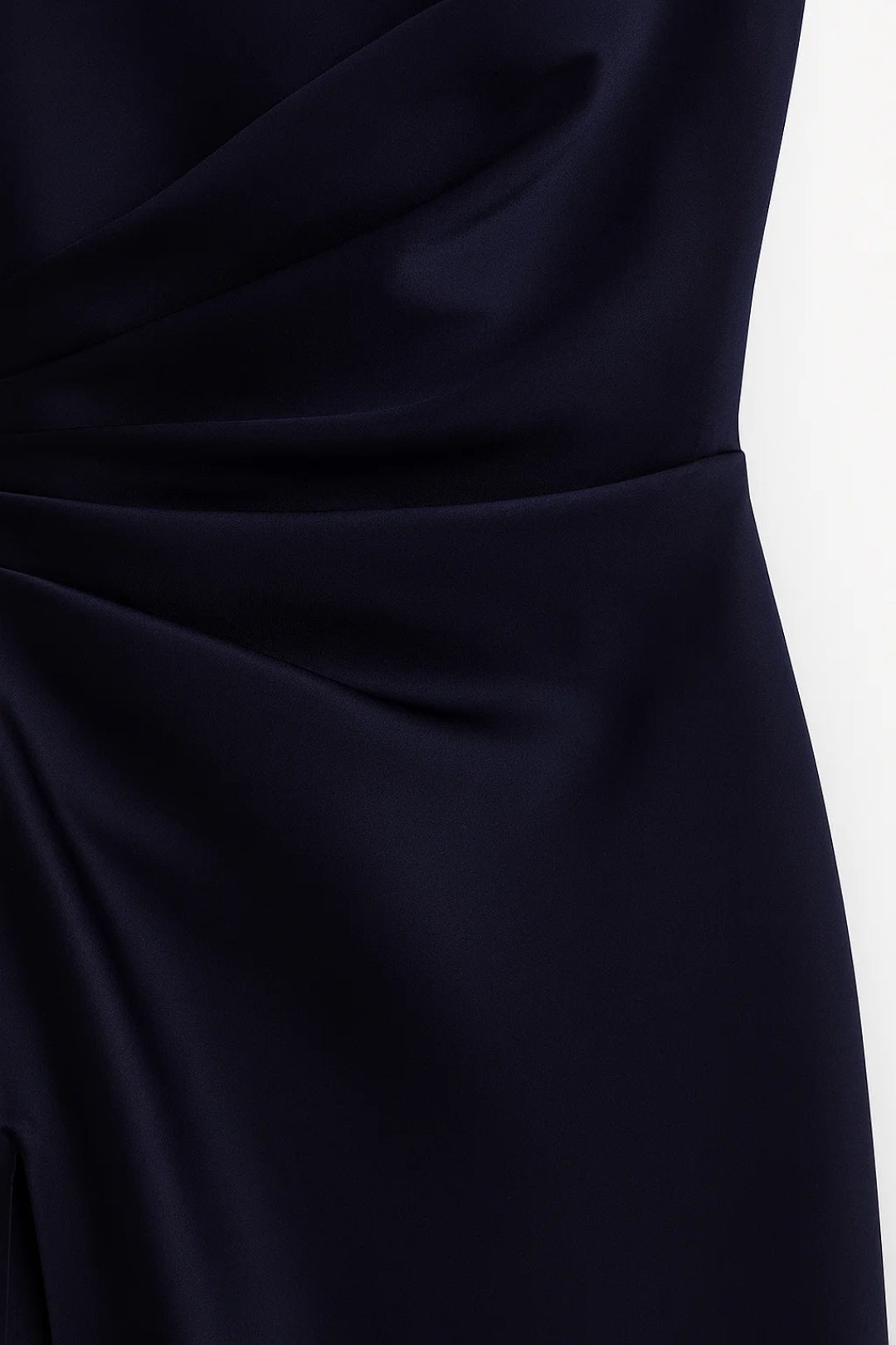 Close-up of dark blue one-shoulder maxi dress showing satin-like fabric texture and hidden zipper