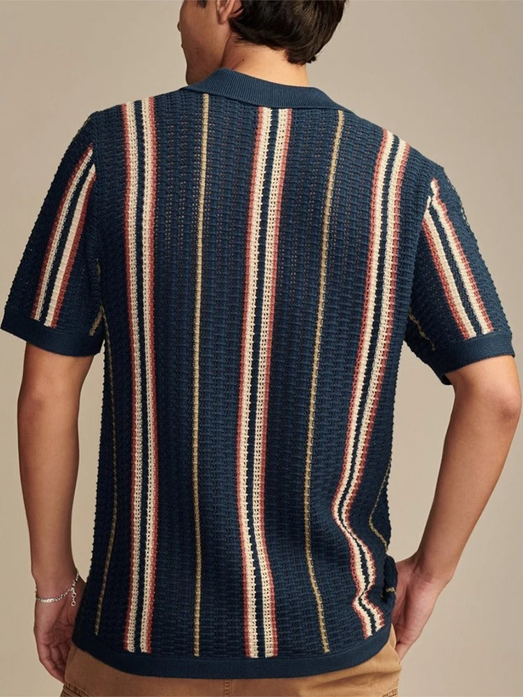 Men's navy blue polo shirt showing contrast panel and short sleeve detail – side or angled view