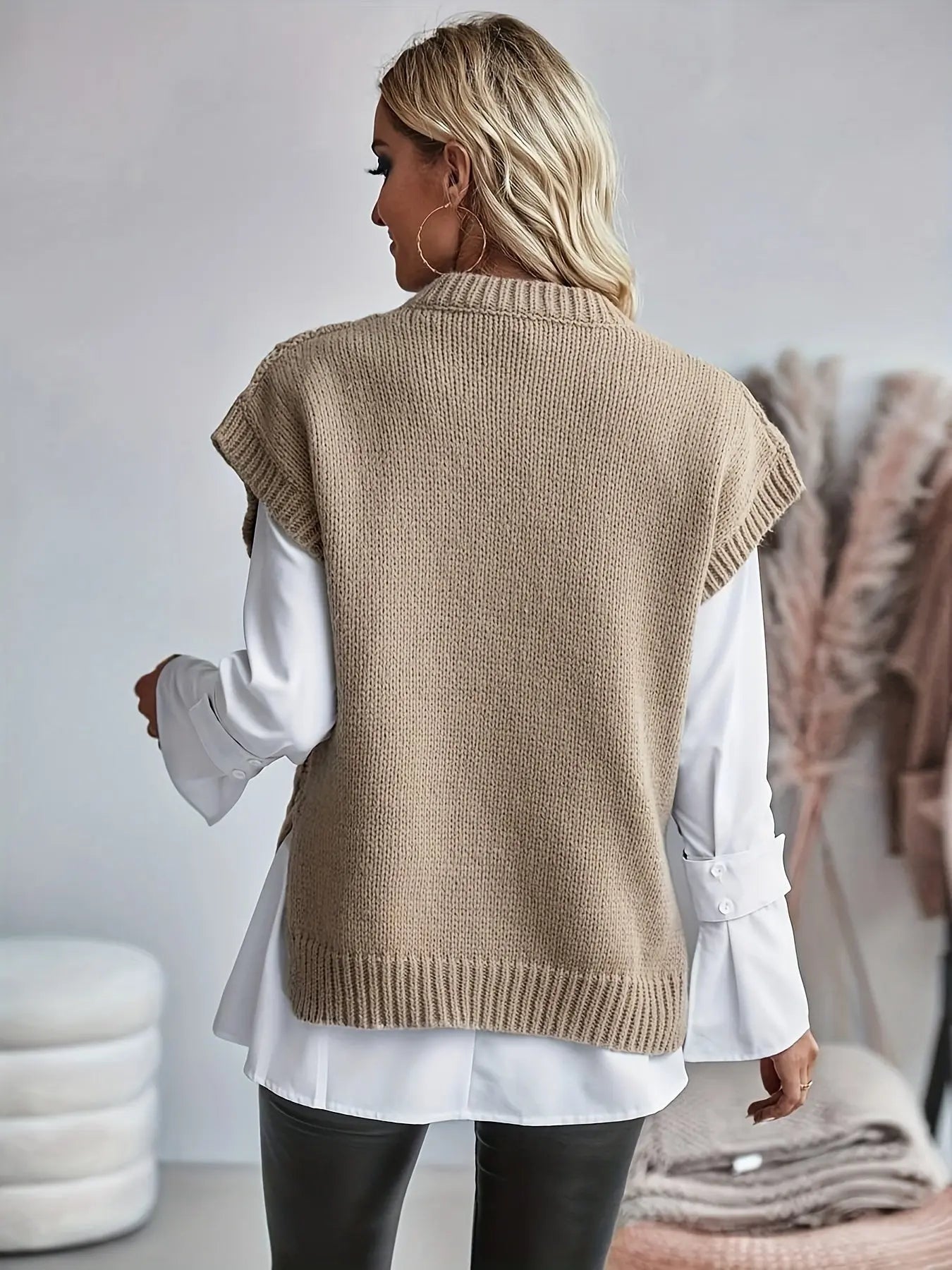 sleeveless fitted knit top displayed on model from front angle
