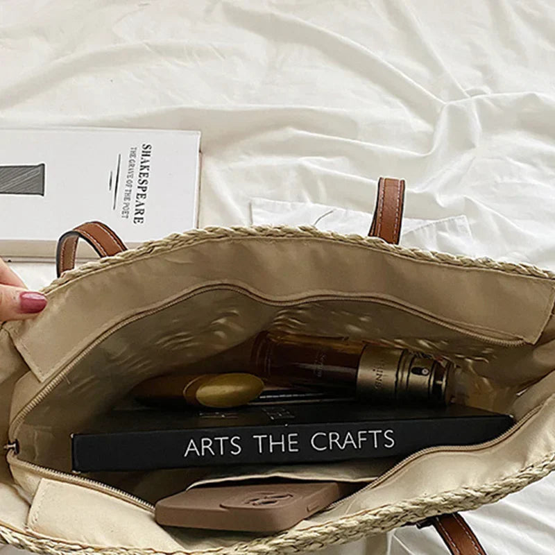 Women's woven shoulder bag in beige – top view showing zipper and main compartment