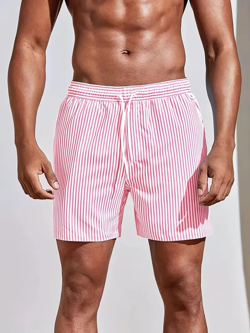 Person wearing red and white striped swim shorts on a plain background