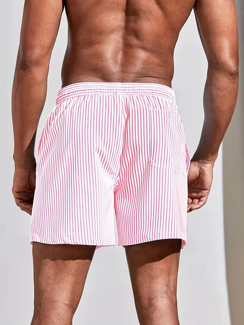 Person wearing red and white striped boxer shorts on a plain background